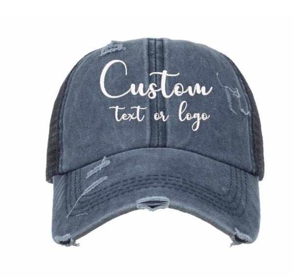 Custom logo embroidery on navy ponytail cap, distressed vintage style visor